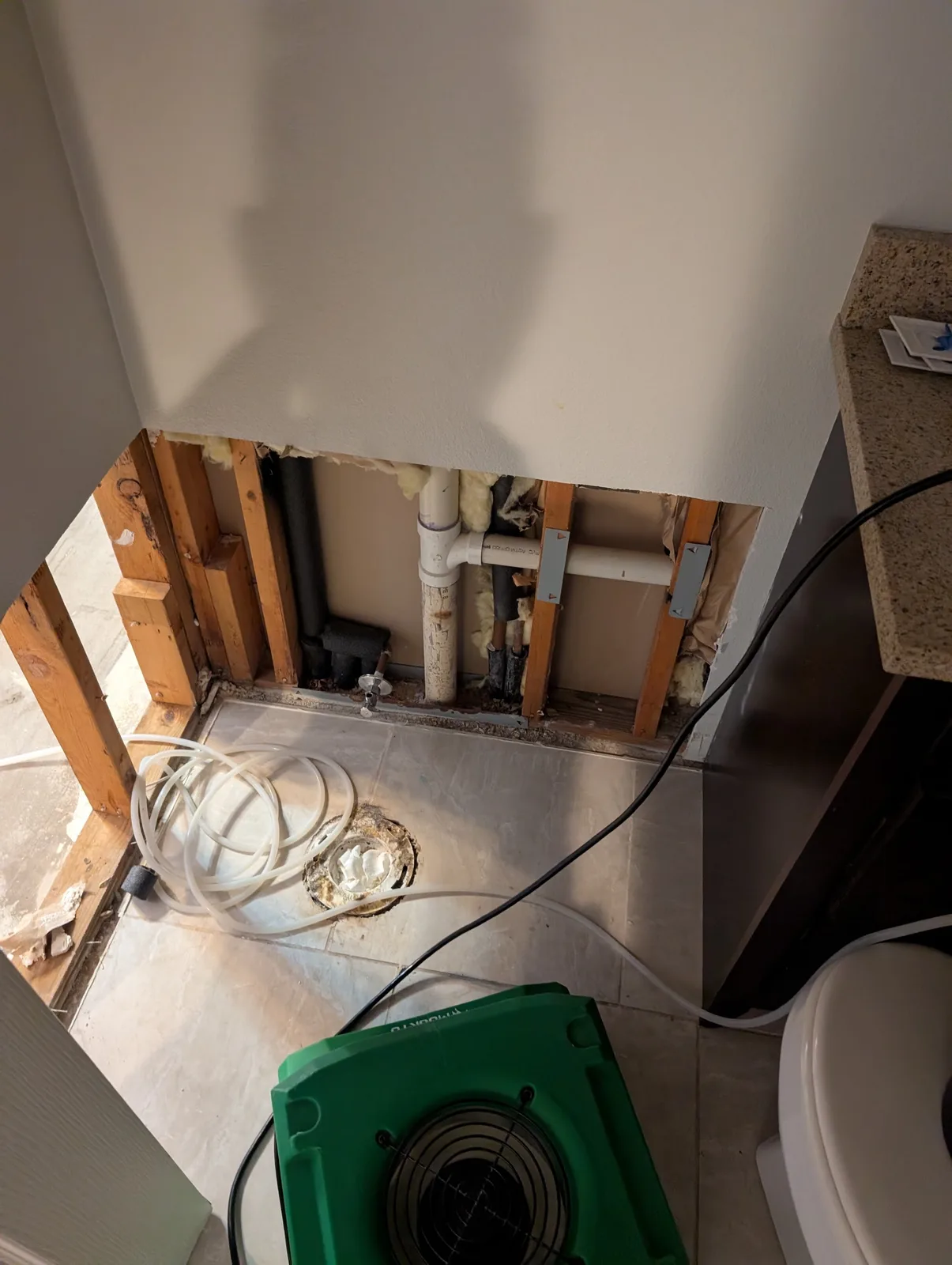 Bathroom demolished to the studs for structural drying after a water heater failure in a Plano, TX home