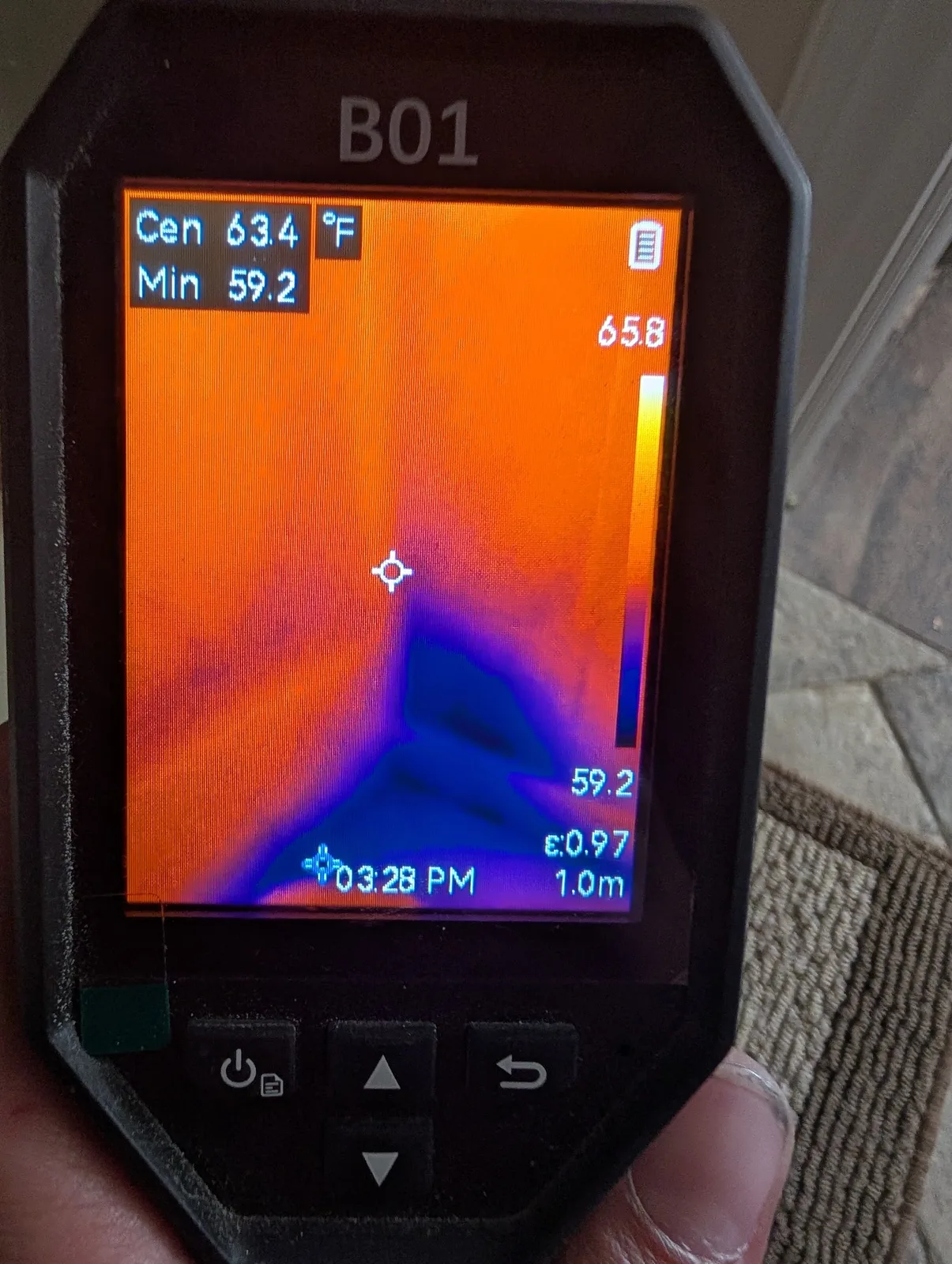 Thermal camera revealing hidden moisture at the base of a wall during a water damage inspection